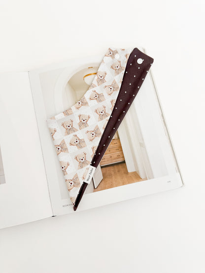 Teddy bear with polka dots quilt